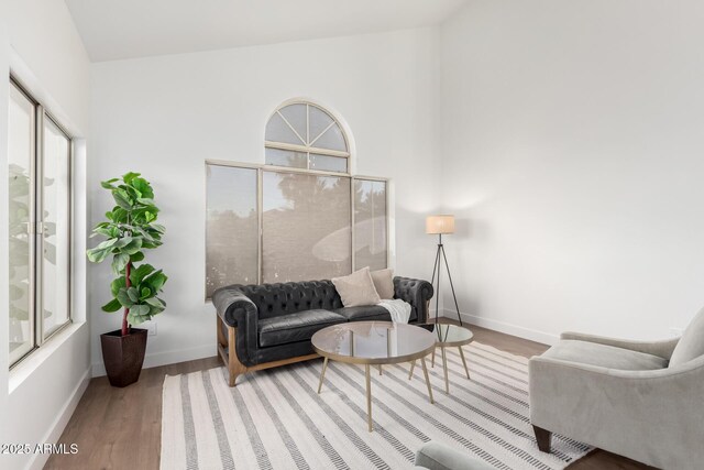 living area with wood finished floors and baseboards