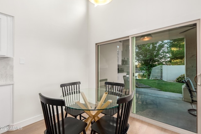 dining room with light wood finished floors and baseboards