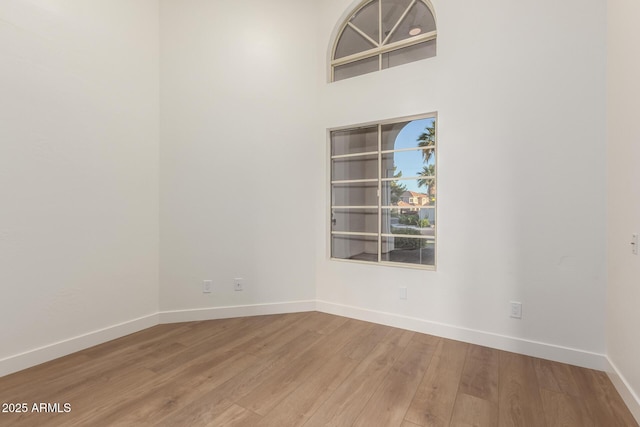 unfurnished room with wood finished floors and baseboards