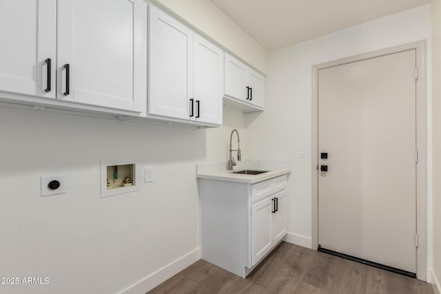 laundry room featuring hookup for an electric dryer, washer hookup, cabinet space, light wood-style flooring, and baseboards