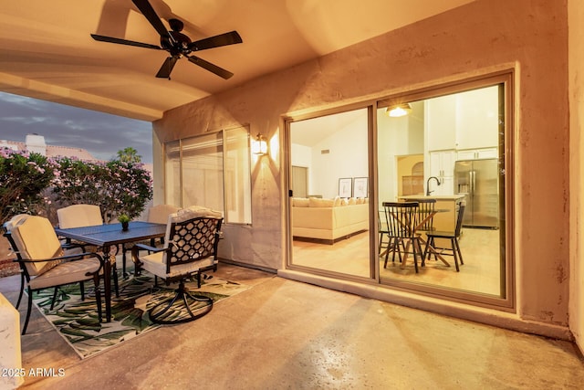 view of patio with outdoor dining space and a ceiling fan