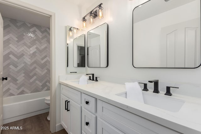 full bath with toilet, double vanity, and shower / washtub combination