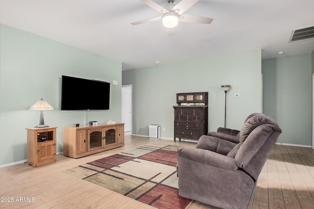 living room with light hardwood / wood-style floors and ceiling fan