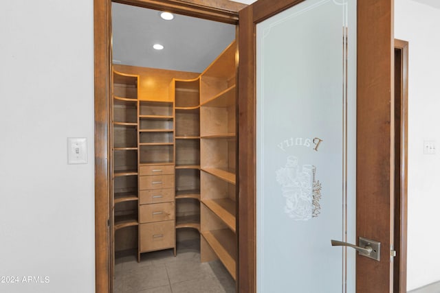 spacious closet with light tile patterned flooring