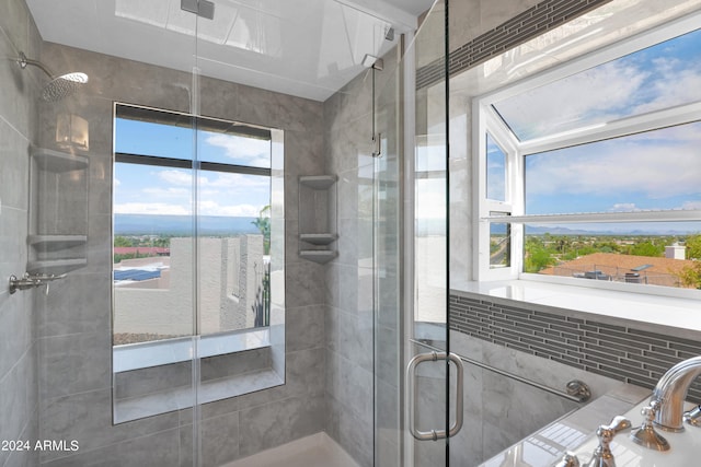 bathroom featuring a shower with door