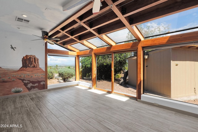 unfurnished sunroom featuring lofted ceiling and ceiling fan