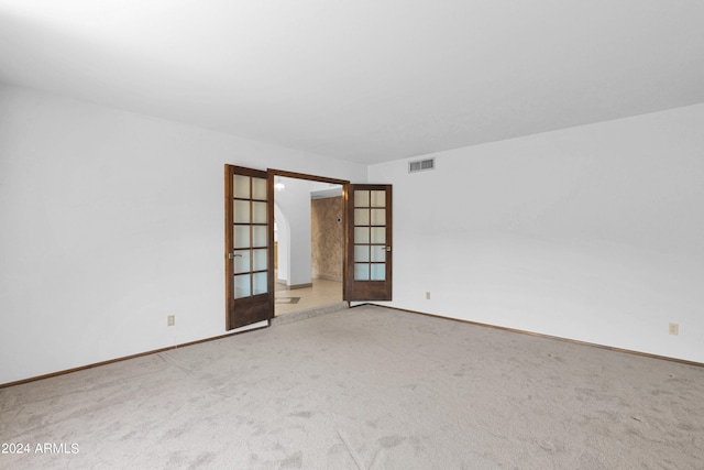 empty room featuring carpet floors and french doors