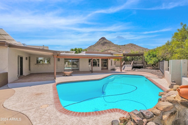 view of pool with a mountain view, a patio, a fenced in pool, and fence