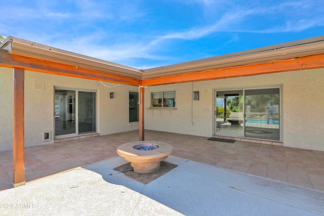 view of patio featuring an outdoor fire pit