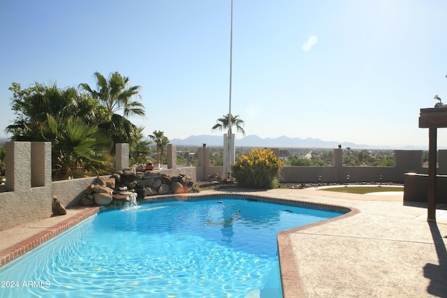 pool featuring a patio area and a mountain view