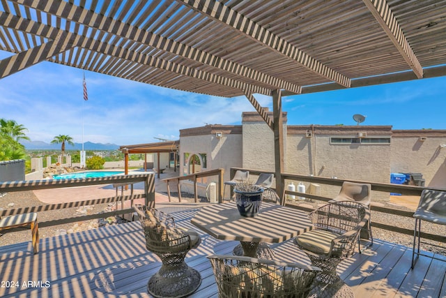 wooden deck with a mountain view and a pergola