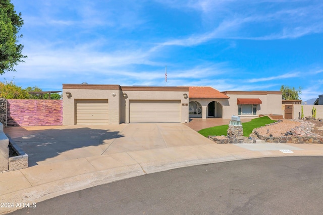 view of front of house featuring stucco siding, driveway, and an attached garage