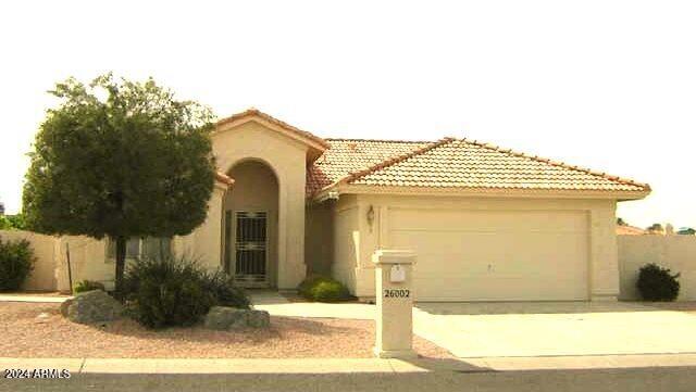 mediterranean / spanish-style house with a garage