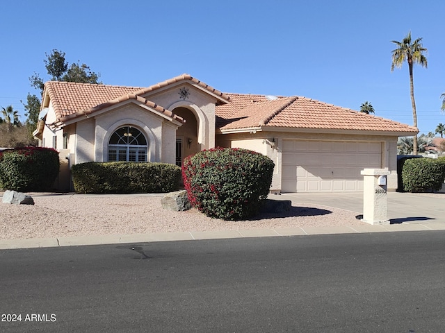 mediterranean / spanish-style home featuring a garage