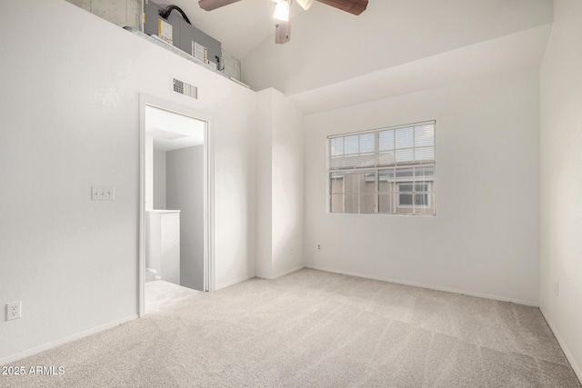 carpeted empty room with baseboards, visible vents, high vaulted ceiling, and a ceiling fan