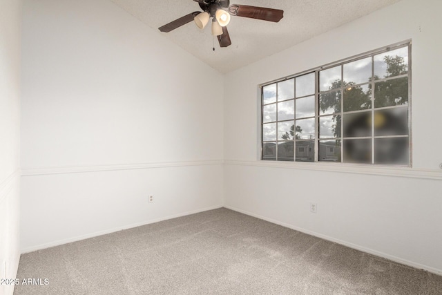 spare room featuring baseboards, a ceiling fan, lofted ceiling, and carpet floors