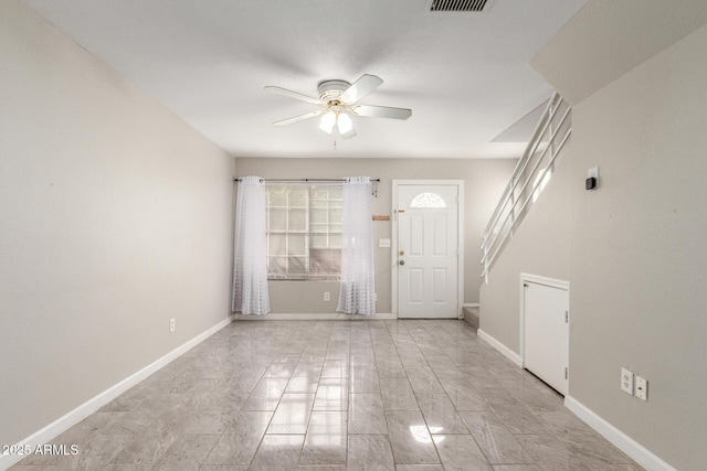 foyer entrance with visible vents, baseboards, and ceiling fan