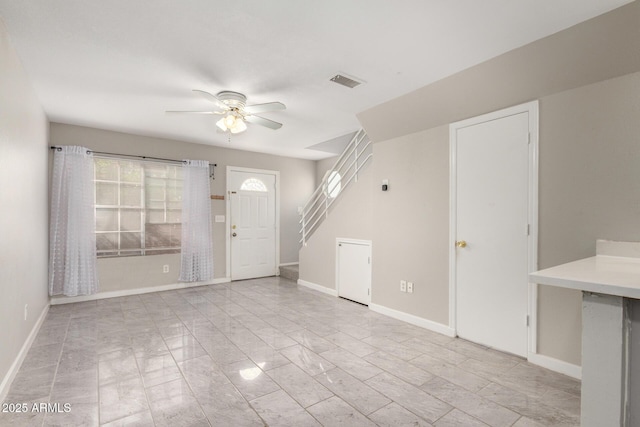 entrance foyer with a wealth of natural light, visible vents, stairs, and baseboards