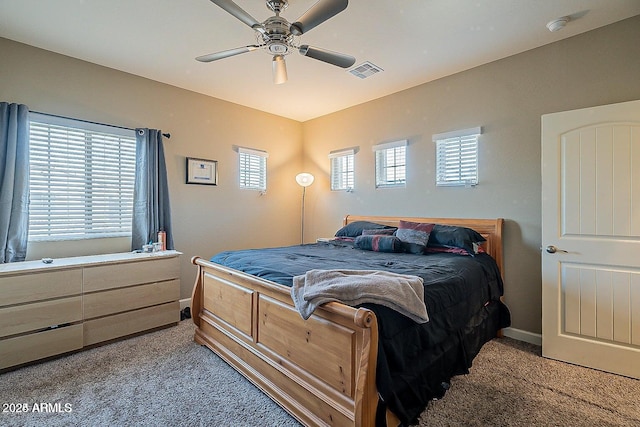 carpeted bedroom featuring baseboards and a ceiling fan