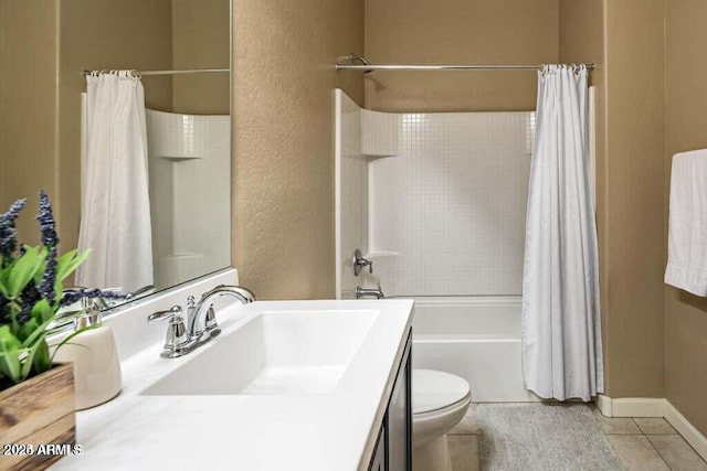 bathroom with a textured wall, tile patterned floors, toilet, vanity, and shower / tub combo