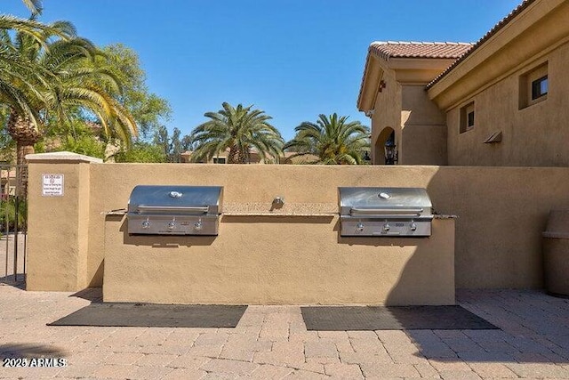 view of patio / terrace featuring a grill and exterior kitchen
