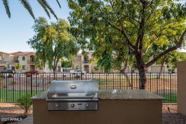 view of patio / terrace featuring a grill, fence, and a residential view