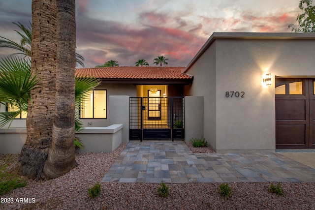 view of exterior entry at dusk