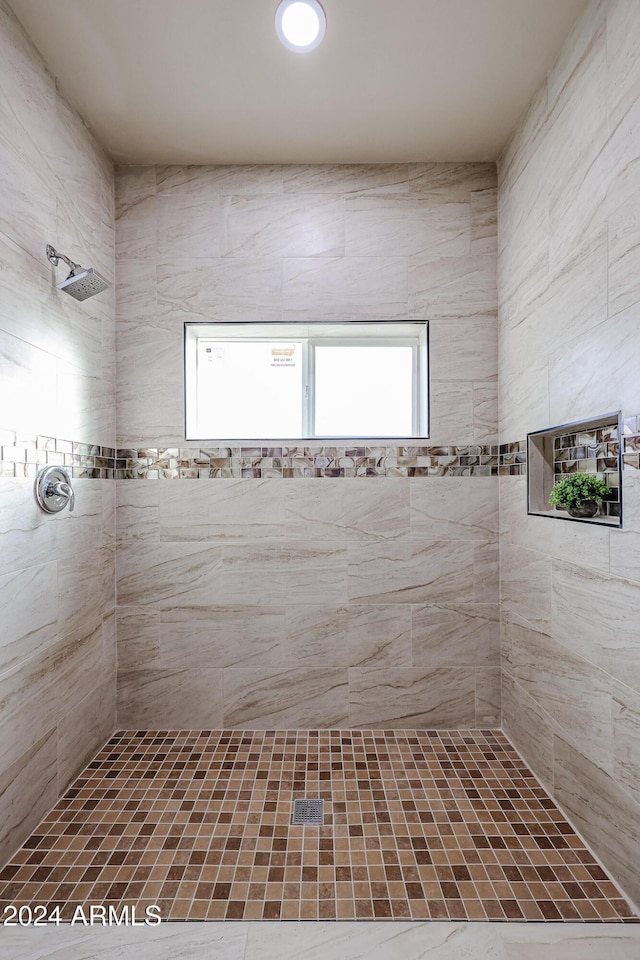 bathroom featuring tiled shower