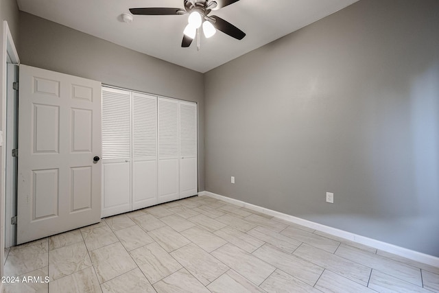 unfurnished bedroom featuring ceiling fan and a closet