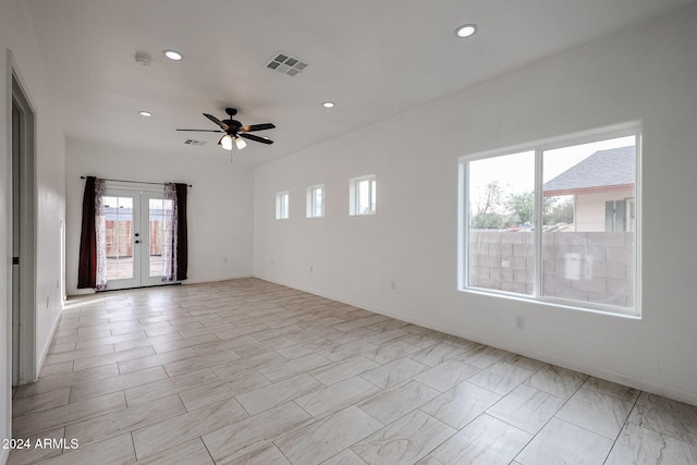 spare room with ceiling fan and french doors