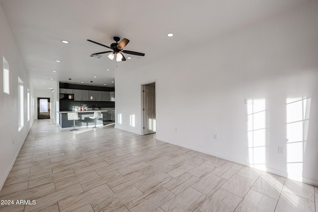 unfurnished living room featuring ceiling fan