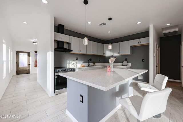 kitchen featuring a center island, light stone counters, gray cabinetry, and electric stove