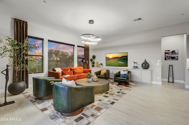 living room featuring a chandelier and light hardwood / wood-style floors