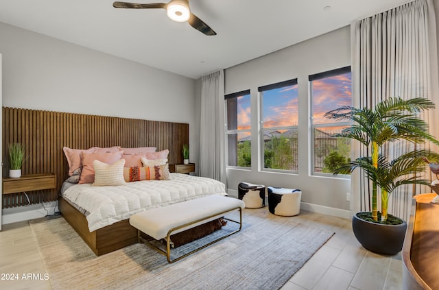 bedroom with light hardwood / wood-style flooring and ceiling fan