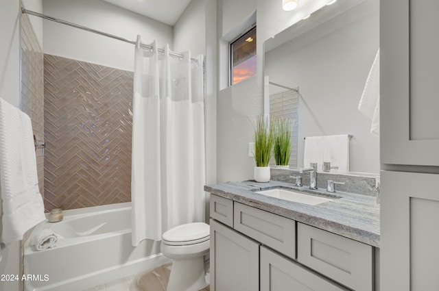 full bathroom featuring shower / bath combination with curtain, vanity, and toilet