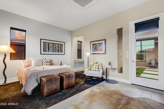 bedroom with light tile patterned flooring and access to exterior