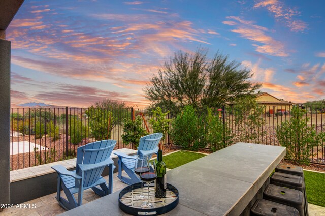 view of patio terrace at dusk