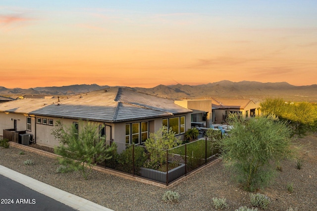 view of front of property featuring central AC unit and a mountain view