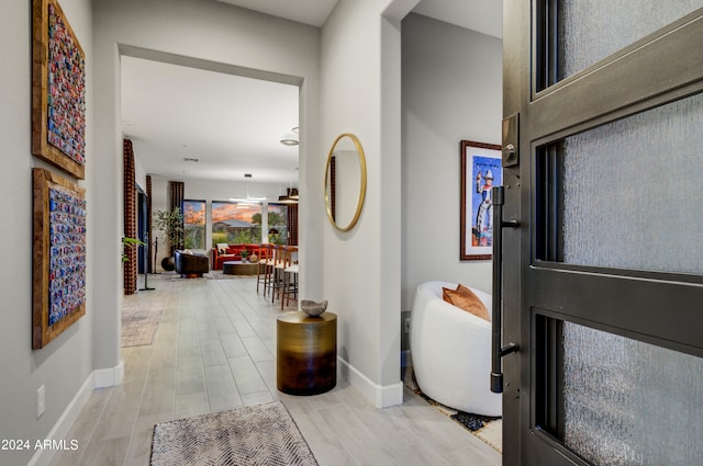 hall with light hardwood / wood-style flooring