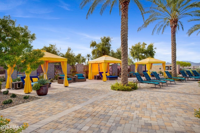 view of jungle gym featuring a gazebo and a patio