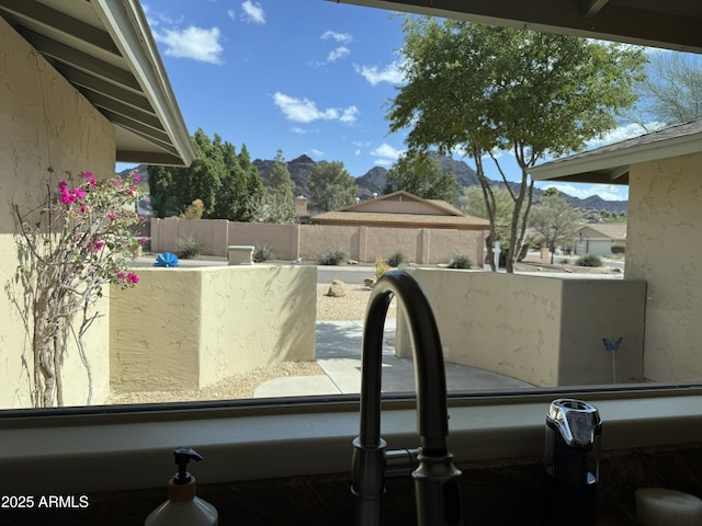 details featuring a mountain view and stucco siding