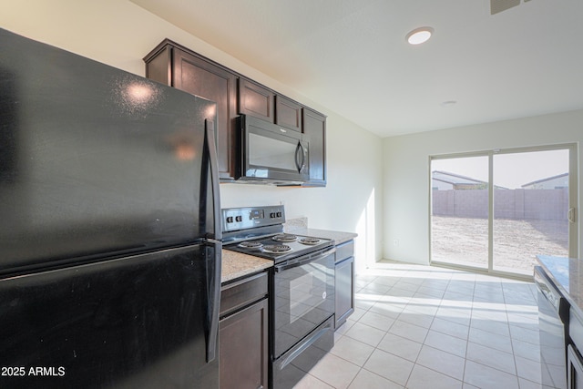 kitchen featuring light stone counters, light tile patterned floors, black appliances, and dark brown cabinets