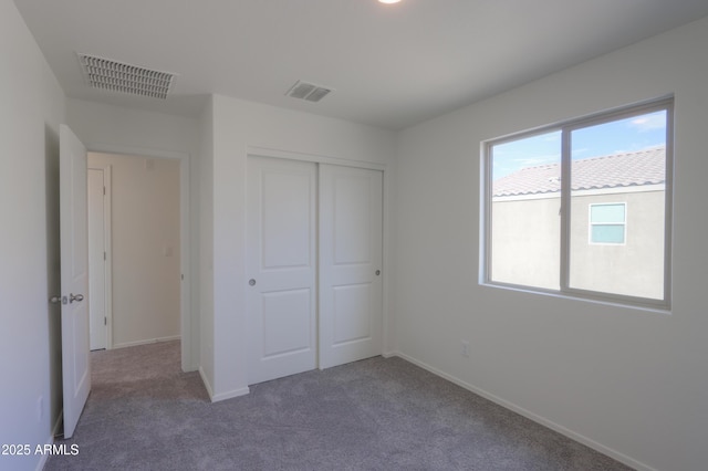 unfurnished bedroom featuring carpet floors and a closet