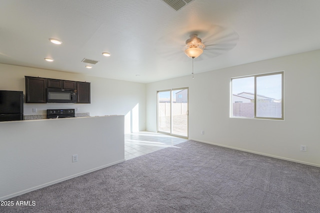 kitchen with light carpet, dark brown cabinetry, and black appliances