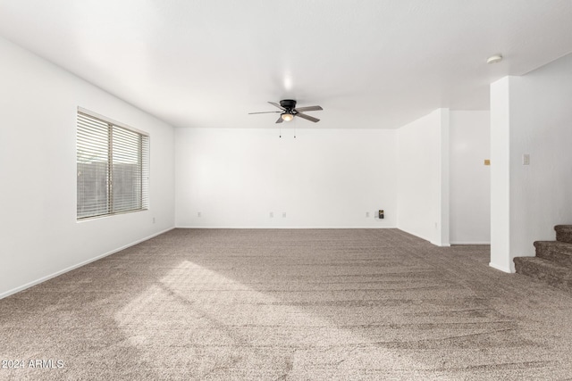 carpeted empty room featuring ceiling fan