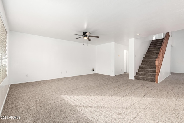 unfurnished living room featuring carpet and ceiling fan