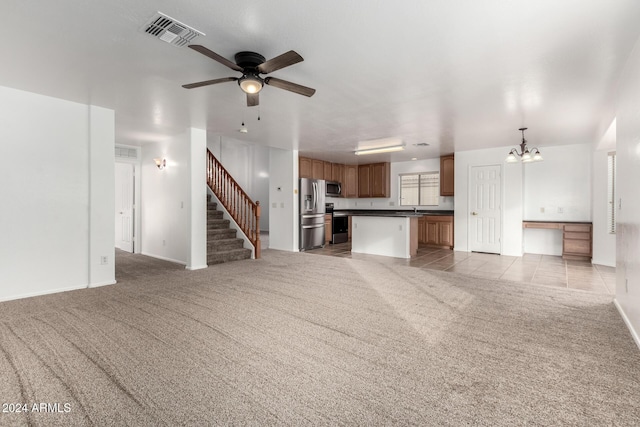 unfurnished living room featuring ceiling fan with notable chandelier, sink, and light carpet