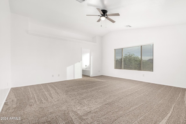 empty room featuring carpet flooring, ceiling fan, and vaulted ceiling