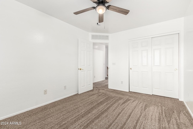 unfurnished bedroom with ceiling fan, a closet, and carpet floors