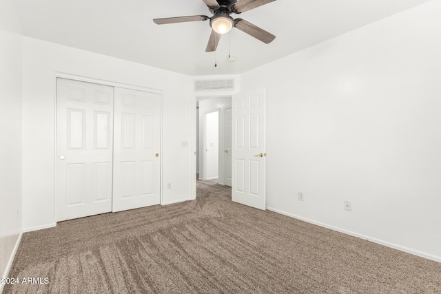 unfurnished bedroom with carpet flooring, ceiling fan, and a closet